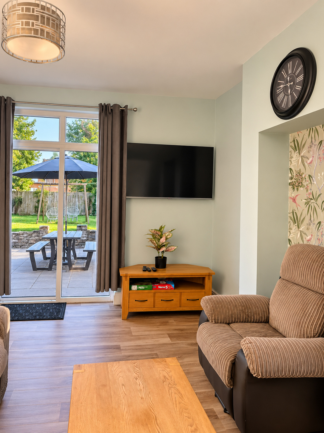 Cosy lounge with TV and armchairs at Ivie Lodge