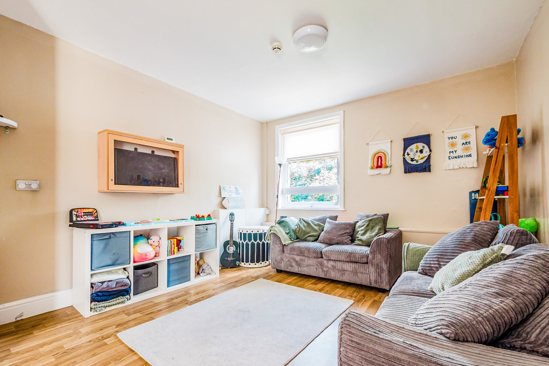 Cosy playroom with sofas, toys and wall hangings